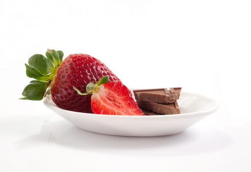 Strawberries and chocolate on saucer