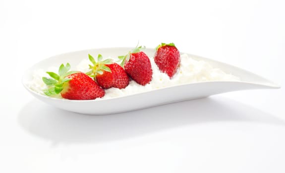 Strawberries and cream on saucer