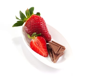 Strawberries and chocolate on saucer
