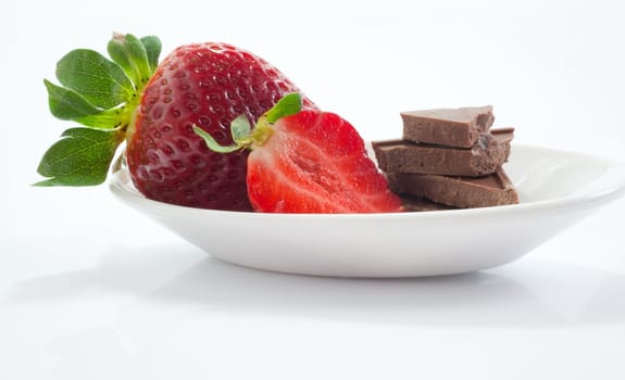 Strawberries and chocolate on saucer