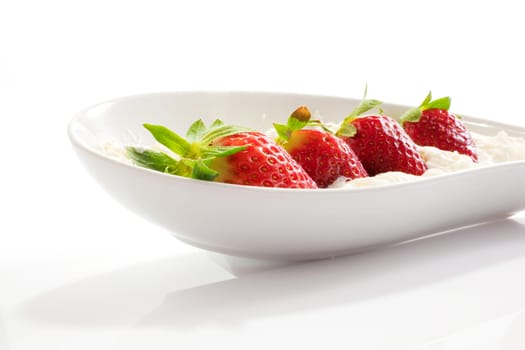 Strawberries and cream on saucer