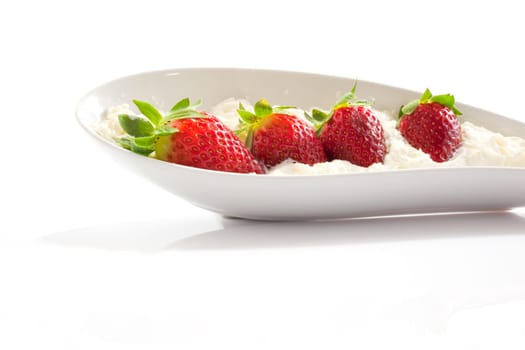 Strawberries and cream on saucer