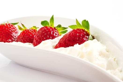 Strawberries and cream on saucer