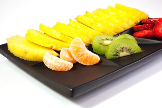 Sliced fruits on black saucer