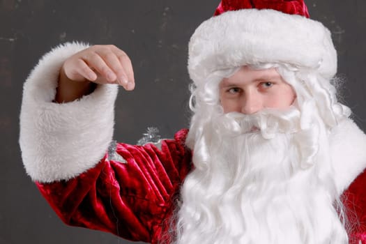 Santa Claus showing onto a red mitten