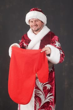 An image of smiling Santa with red bag