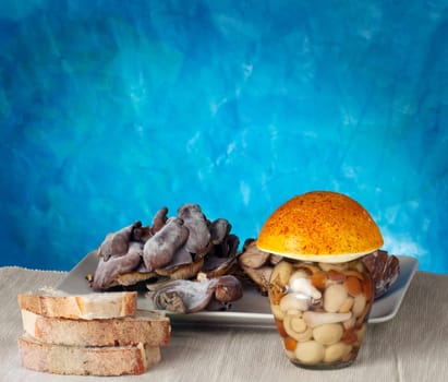 Mushrooms inside a jar on a blue background