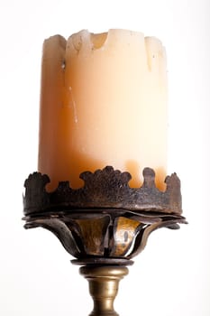 Ancient big candle on white