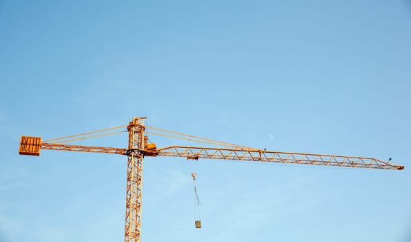 Yellow crane on blue sky