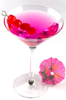 A refreshing cocktail with cherry and decorated with an umbrella