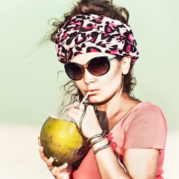 Beautiful woman drinking coconut outdoor