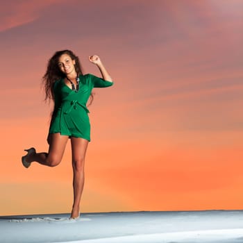 Beautiful woman dancing in desert