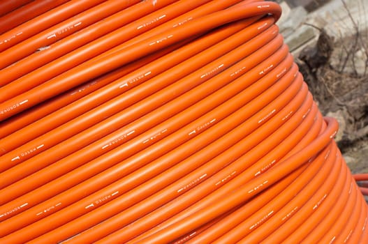 orange telephone cable on a cable drum