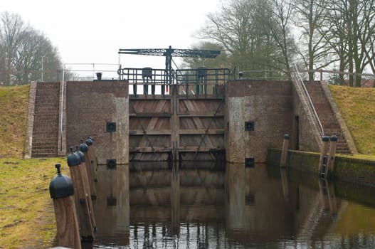 old wooden sluice door in a canal