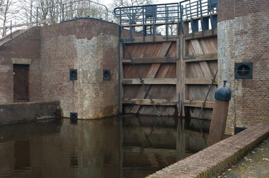 old wooden sluice door in a canal