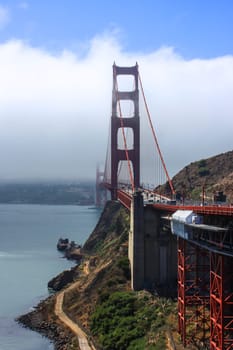 Golden Gate Bridge with a veil of fog with San Francisco in the background