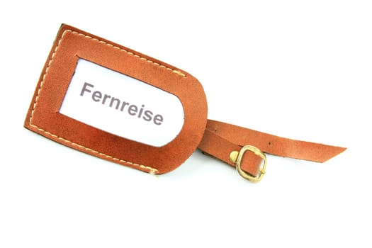 Luggage tag with the inscription "Fernreise"" against a white background"
