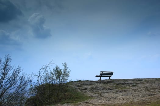 lonely bench on a rocky outcrop