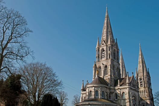 Saint Fin Barre&#039 s cathedral in Cork, Ireland (blue sky background)