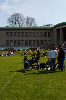 DUBLIN, IRELAND - MARCH 29: students enjoying outdoors at the cricket field in the Trinity College on March 29, 2012 in Dublin, Ireland.Ranked in 2011 by The Times as the 117th world&#039 s best university