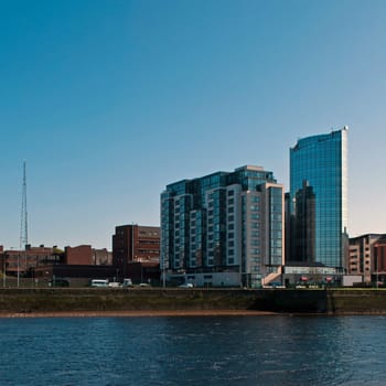Limerick cityscape with Riverpoing buildings over Shannon river, Ireland (gorgeous blue sky, square picture)