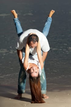 Young couple near the sea at sunrise
