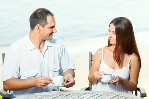 Young couple drinking a morning coffee outdoor