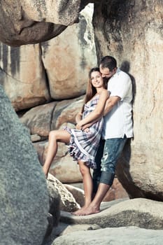 portrait of attractive young couple on the cliff.