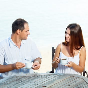 Young couple drinking a morning coffee outdoor