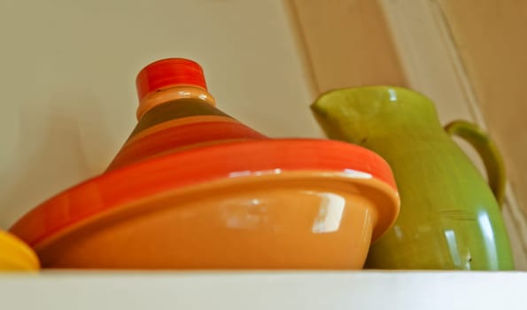 Middle eastern tagine oven and pitch on a generic cottage shelf in England