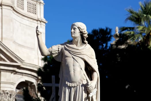 Statue of an ancient religious figure next to the cathedral of Catania