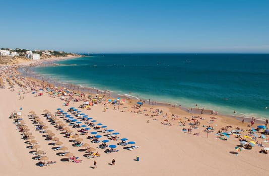 ALBUFEIRA, PORTUGAL - AUGUST 30: tourists and locals enjoying a sunny day at the beach in Algarve on August 30, 2011 in Albufeira, Portugal. It is the most touristic place in the region during all year.