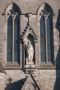 marble sculpture and windows at Saint John&#039 s cathedral in Limerick, Ireland (blue sky background)