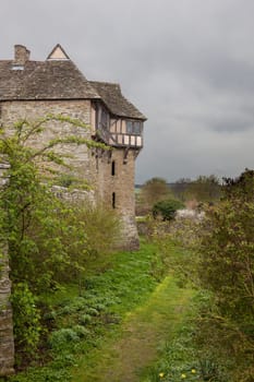 Moat around Stokesay castle on a dark cloudy day