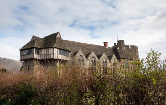 Side view of Stokesay castle in Shropshire surrounded by hedge