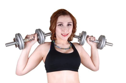 A weight lifting young teenager in closeup in a black sports bra, standing for white background and working out.