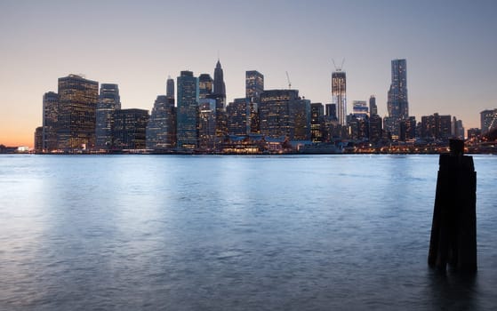 Lower Manhattan at sunset by Brooklyn Bridge