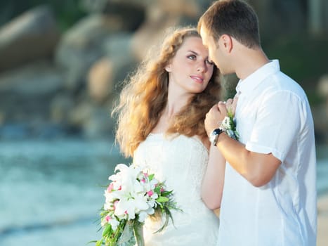 Bride and groom on the beach. Tropical wedding