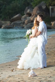 Bride and groom on the beach. Tropical wedding