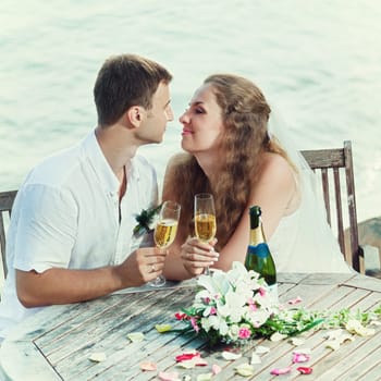 Bride and groom at wedding table near the sea