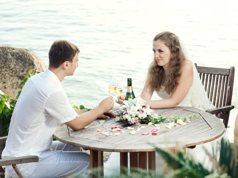 Bride and groom at wedding table near the sea