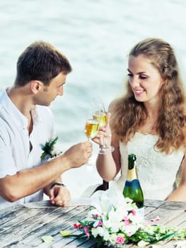 Bride and groom at wedding table near the sea