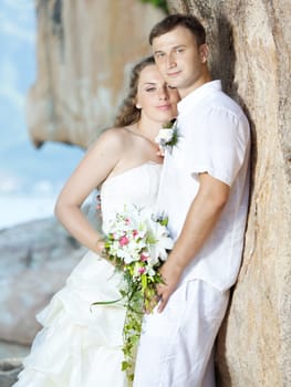Bride and groom near the cliff. Tropical wedding