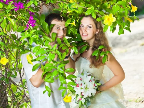 Bride and groom in a tropical garden