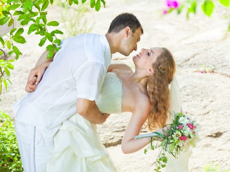 Bride and groom in a tropical garden