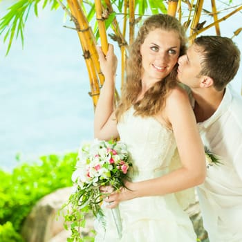 Bride and groom on the beach. Tropical wedding