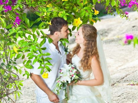 Bride and groom in a tropical garden
