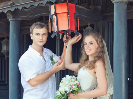 Bride and groom in asian style terrace.