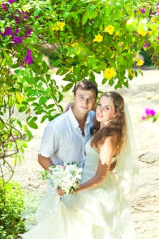 Bride and groom in a tropical garden