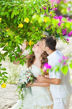 Bride and groom in a tropical garden